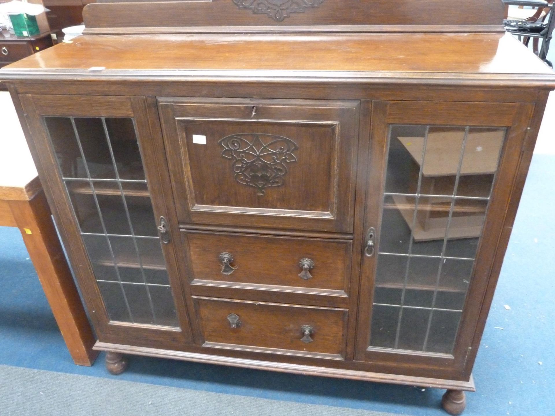 Sideboard with two leaded light doors with central cupboard with drop down door above two drawers (H