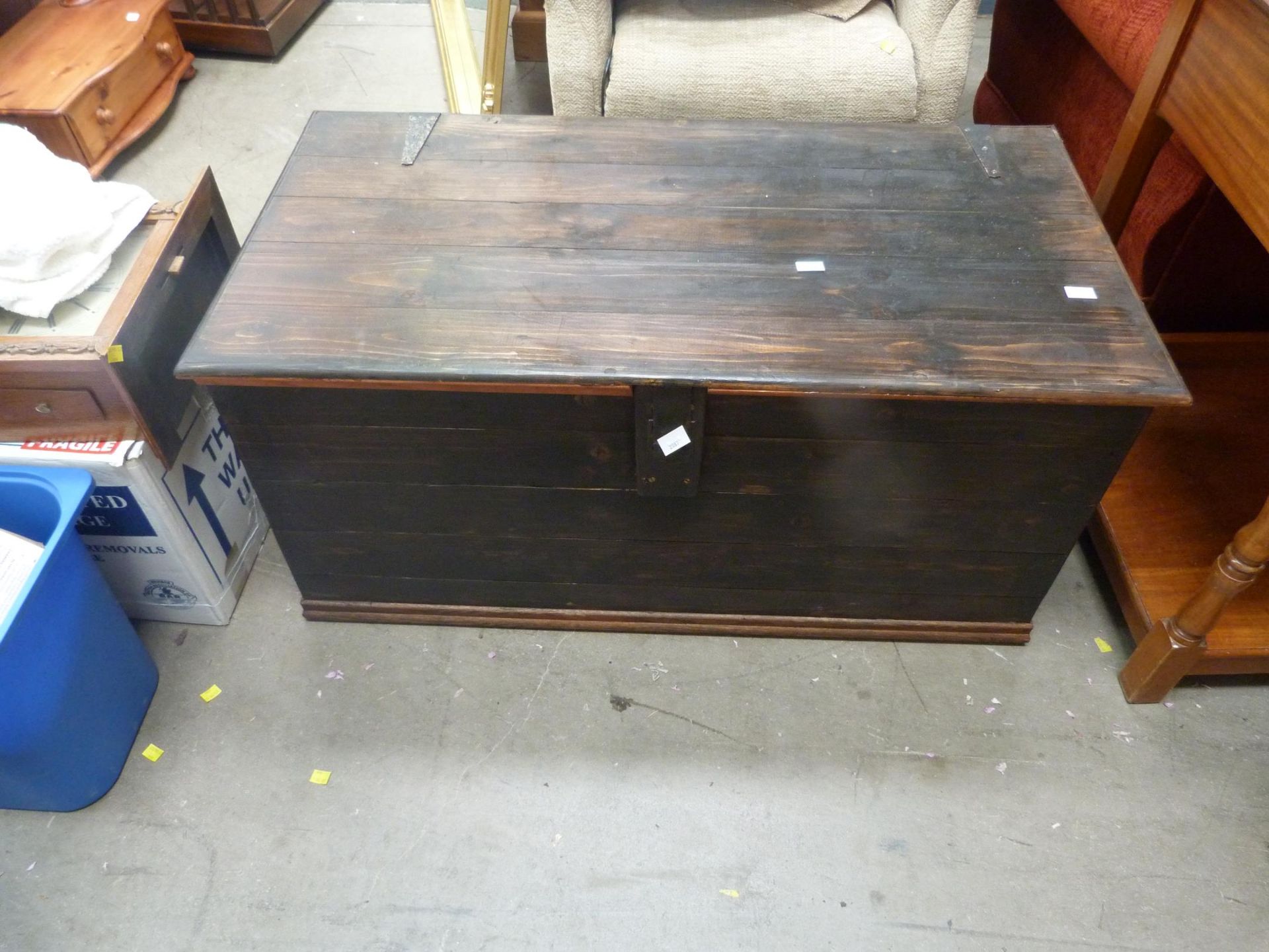 A Wooden Chest with metal fixings and fastenings (H 51cm, W 106cm, D 54cm) (est. £20-£40)