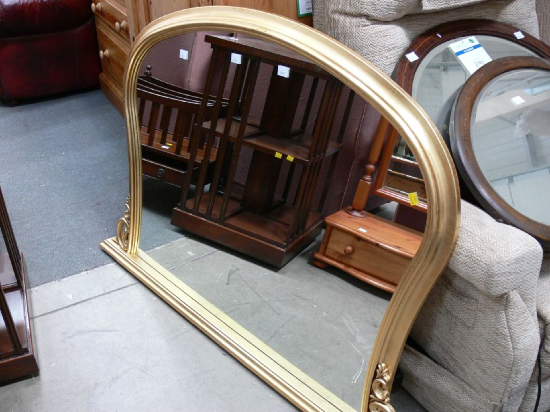 A Shaped Mirror with gold coloured frame (H 90cm, W 127cm, D 6cm) (est. £20-£40)