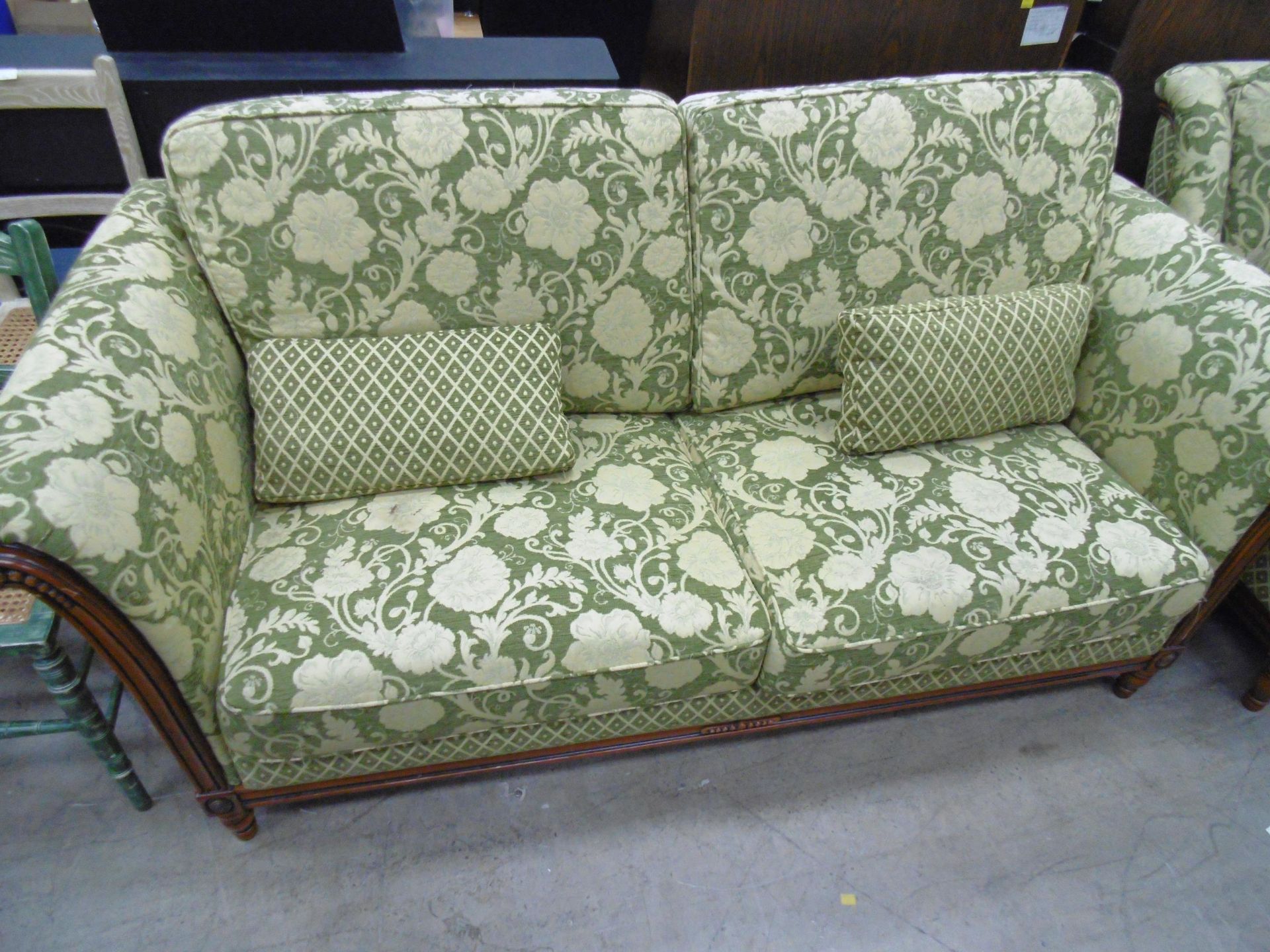 A mainly green Four Piece Suite to include three seat Settee, two single Chairs and Pouffee (4) (est