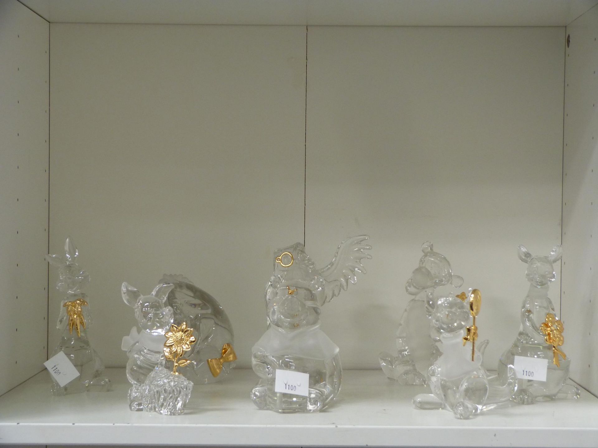 A shelf to contain eight full lead Crystal 'Lenox' Disney Figurines based on 'Winnie the Pooh'