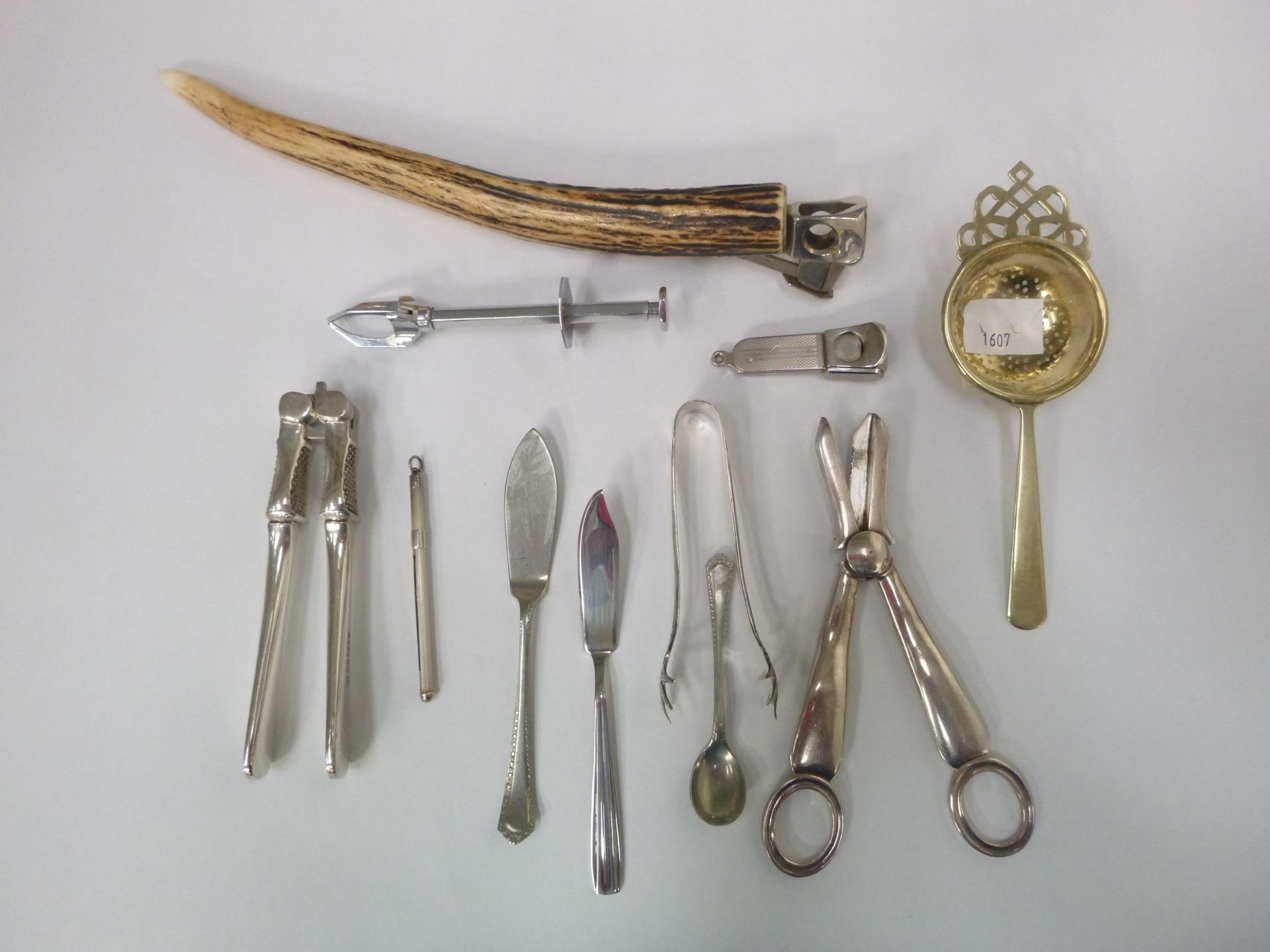 A lot to include a pair of Sterling Silver Cocktail Tongs, Silver Stirrer/Swizzel Stick, 2 Cigar