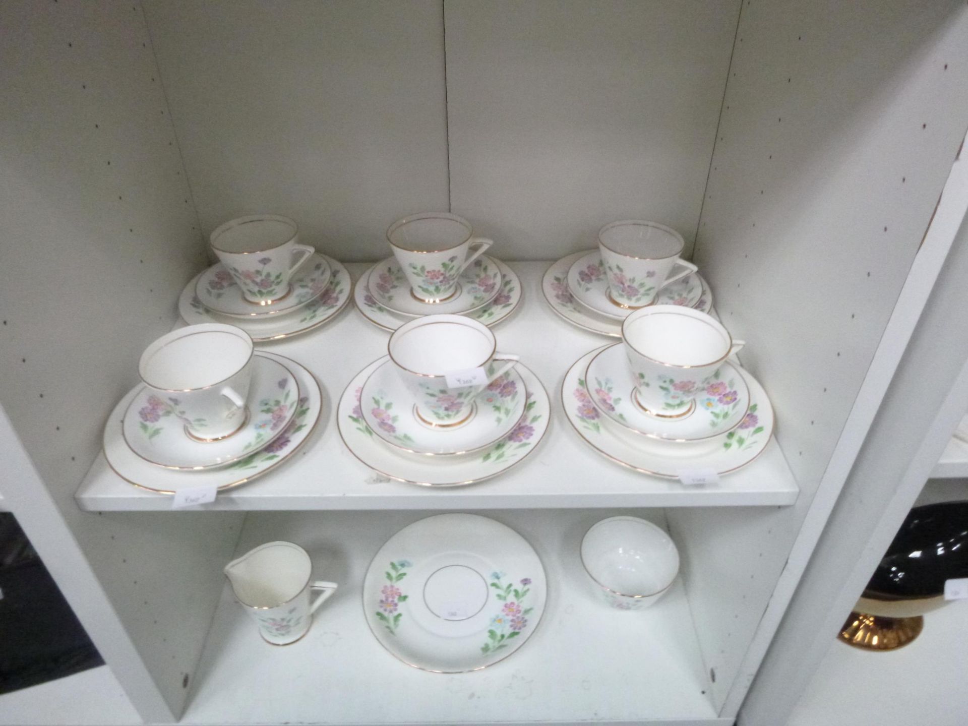 Two shelves to contain a Phoenix Bone China Tea Set with Tea Cups, Saucers etc (est £20-£40)