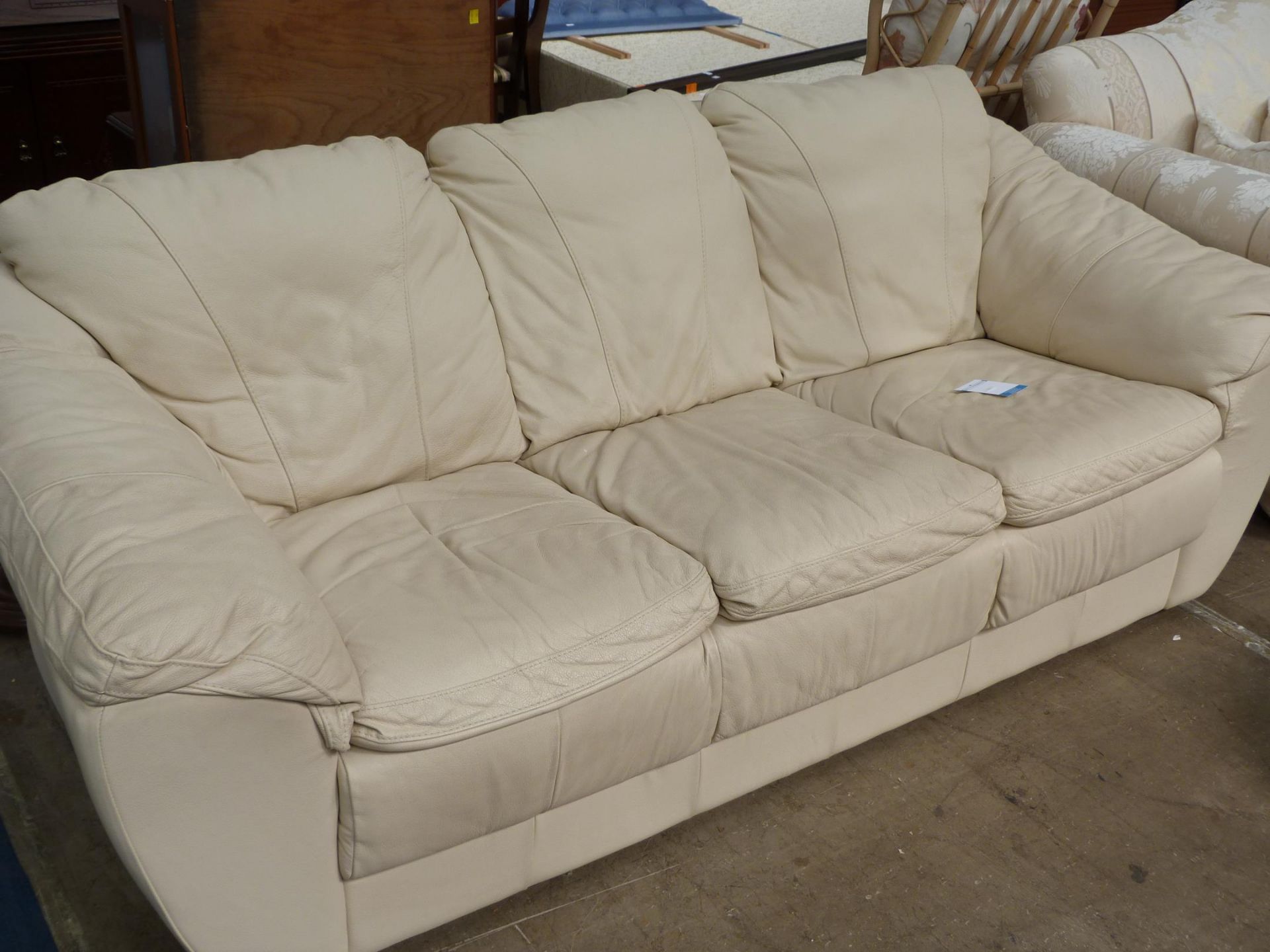 An off white three seat Leather Settee (est £25-£50)