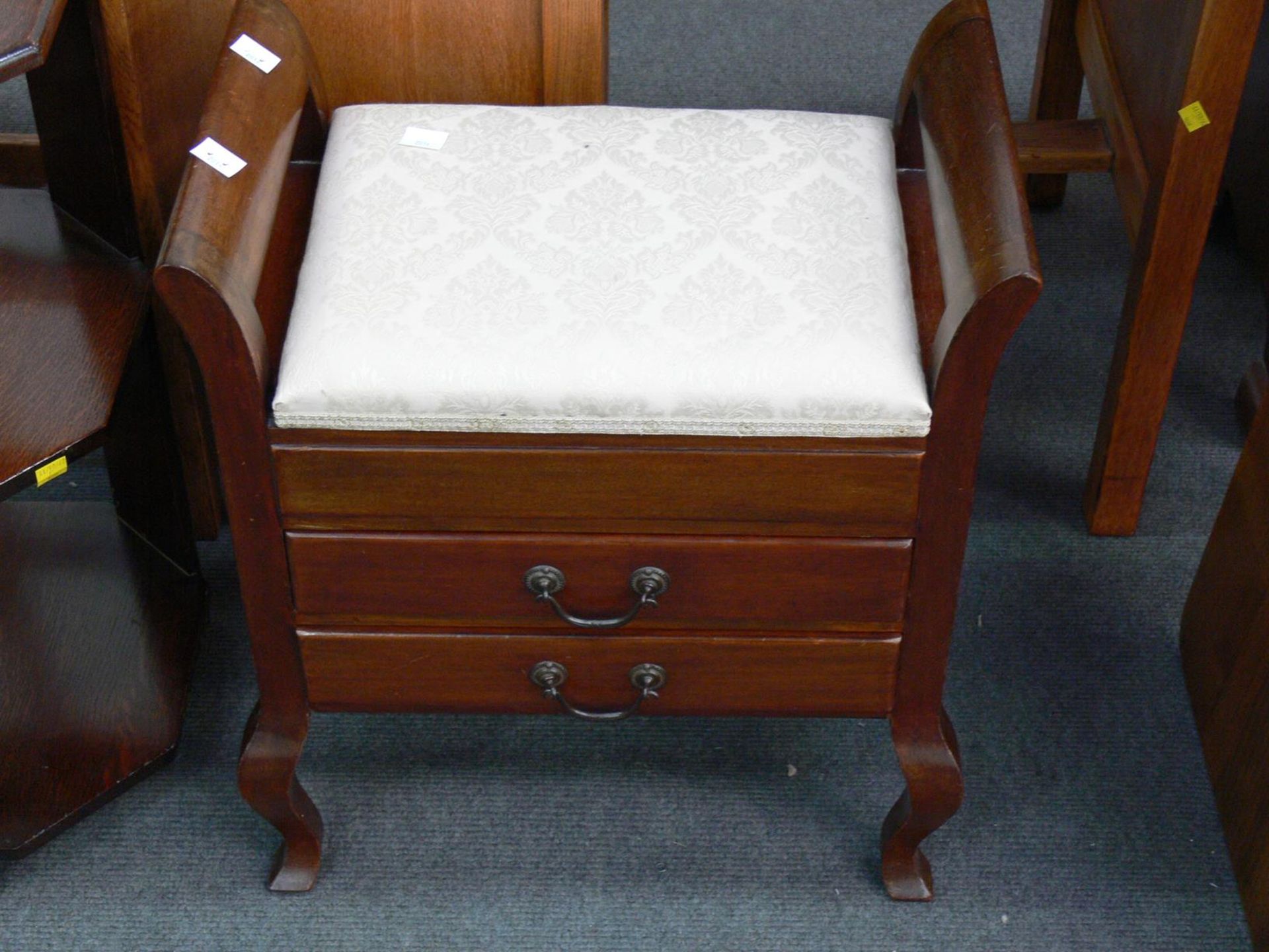 A wooden Piano Stool Seat with carry handles, two drop fronted drawers, Hinged cushioned top