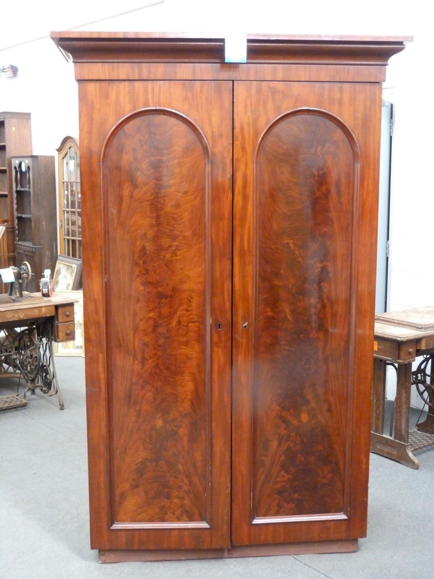 A large two compartment Wardrobe with shelf with John Watts of Sheffield made Metal sliding fixing