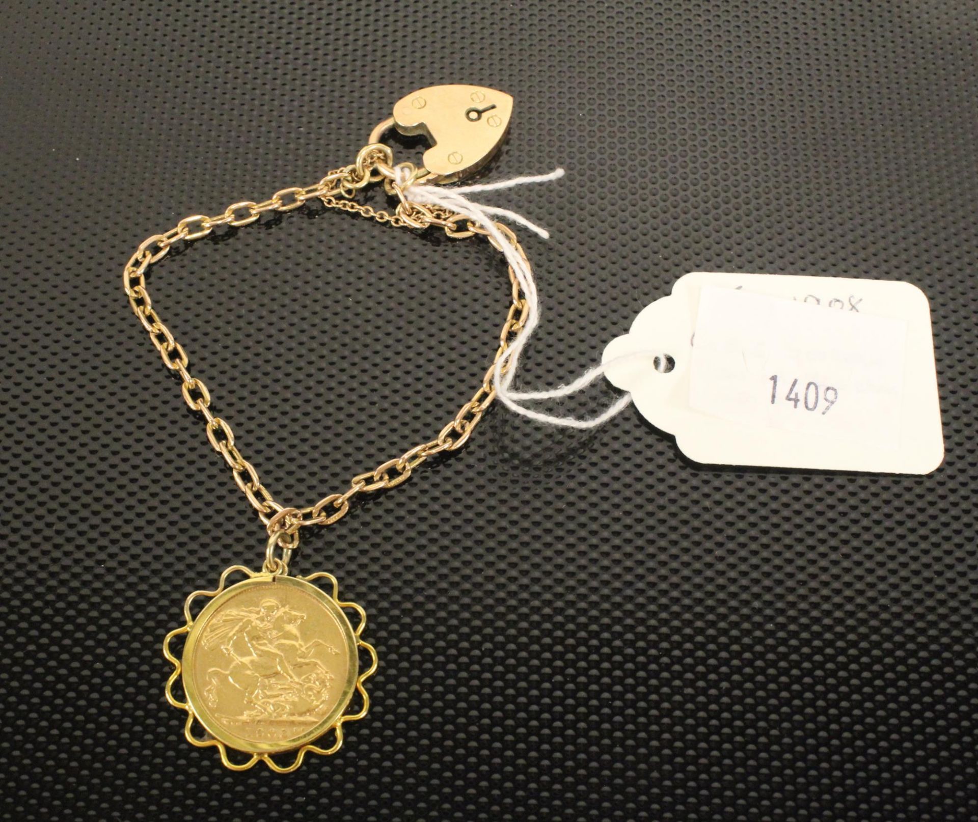 An Edward VII Full sovereign 1908 loosely set in a Gold frame as a pendant Bracelet on a 9ct Gold