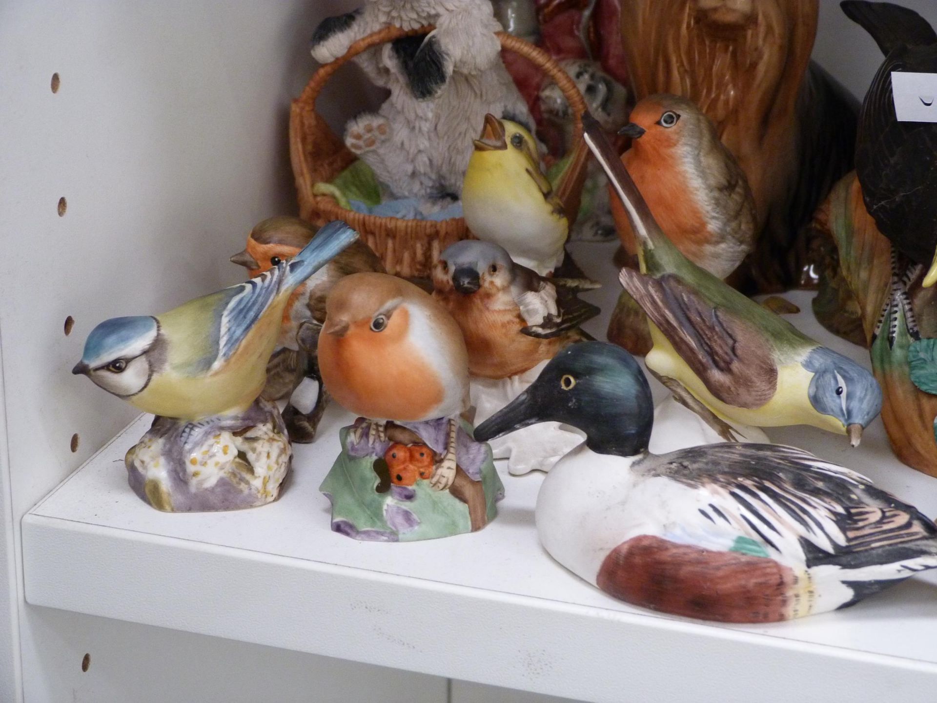 A shelf to include a large variety of figurines, to include Nao-LLadro Geese (A/F) Royal Worcester