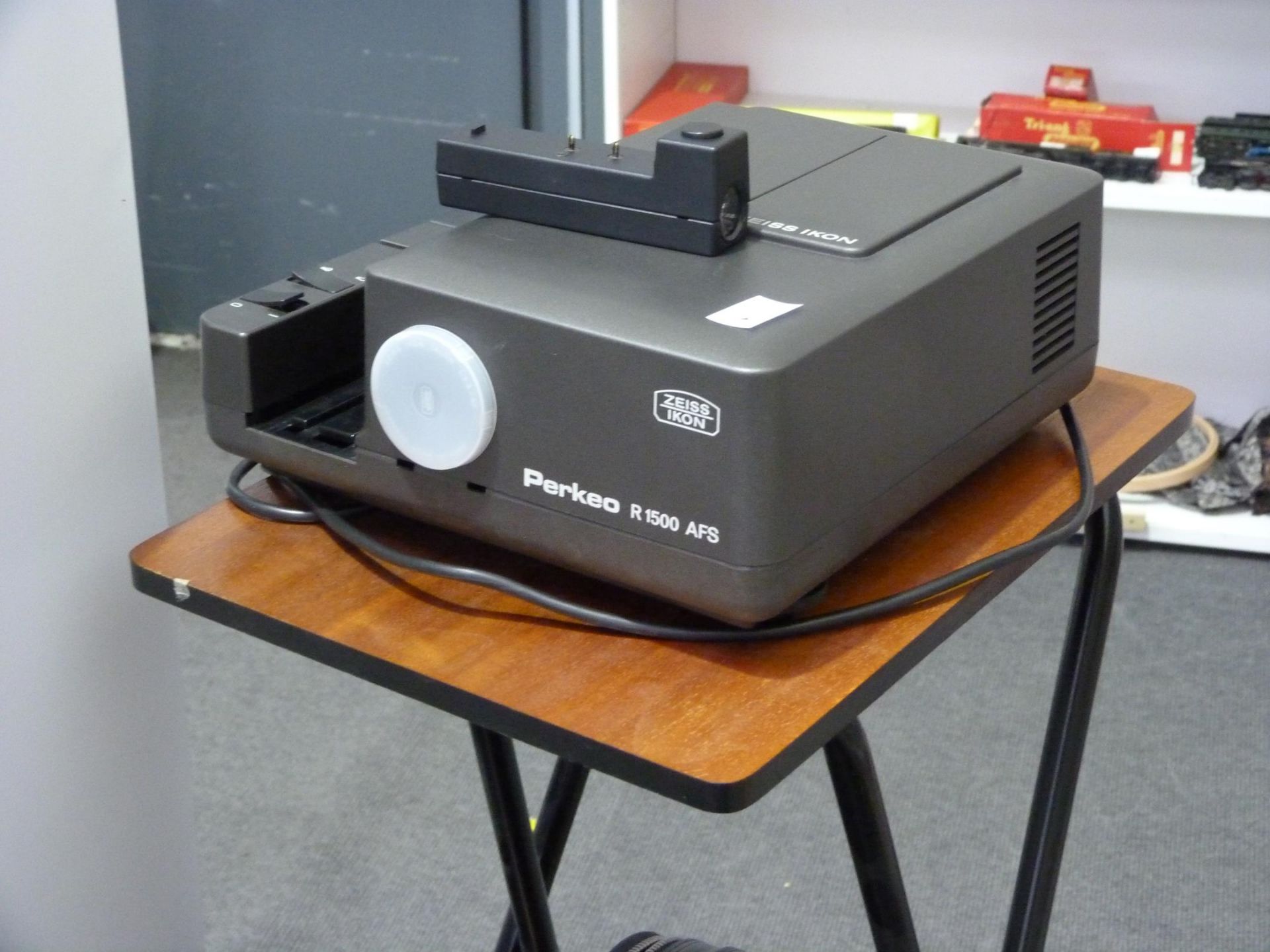 A 'Zeiss Ikon' Slide Projector with case along with a 'Projecta Holland' Screen and a Projector