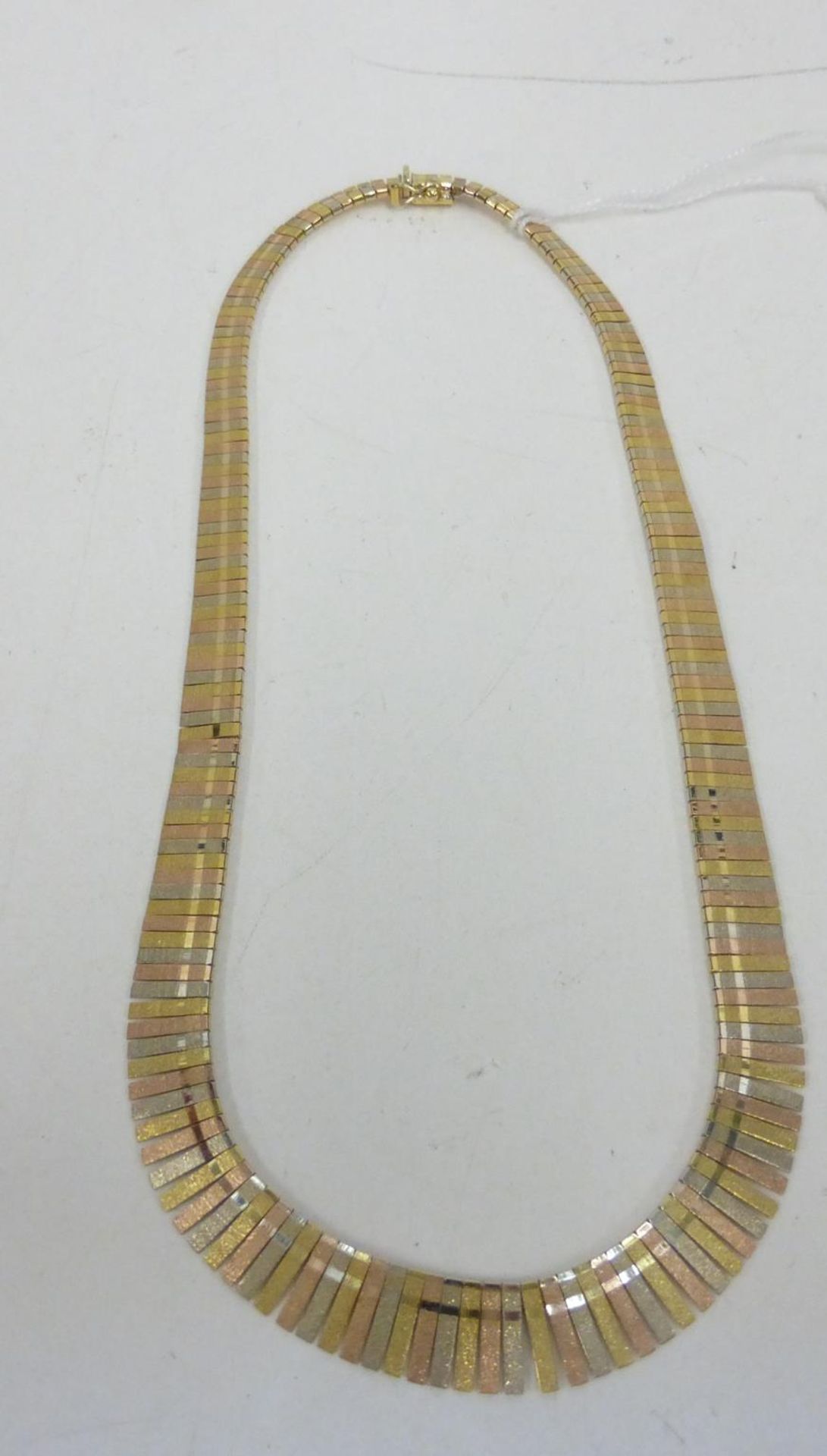 An 18ct Gold tapering with multicolour flexible band Necklet 35gms boxed. (est £700-£900)