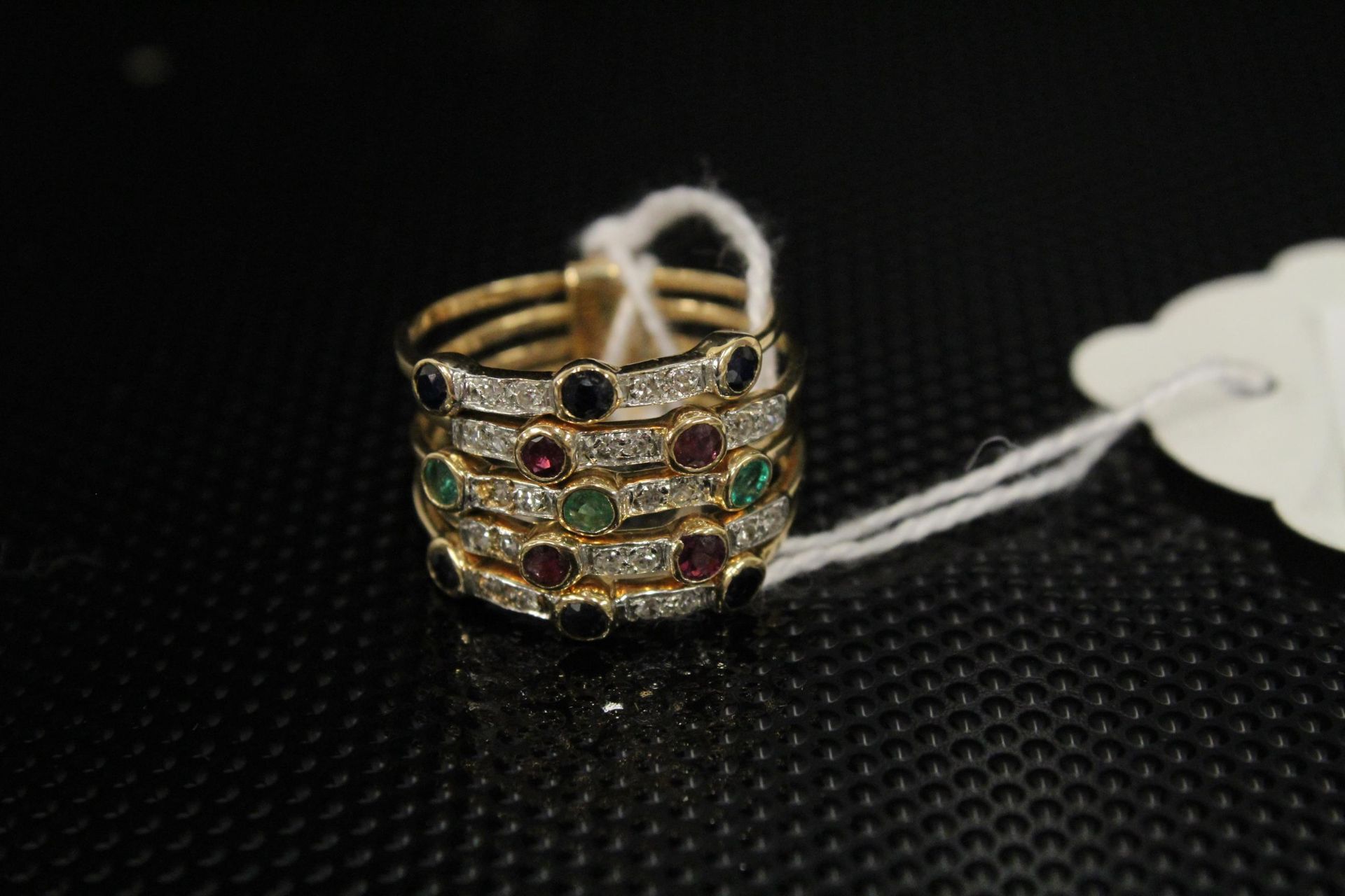 An unusual 14ct Gold Ring as 5 conjoined rings each set with Diamonds and other stones, size M