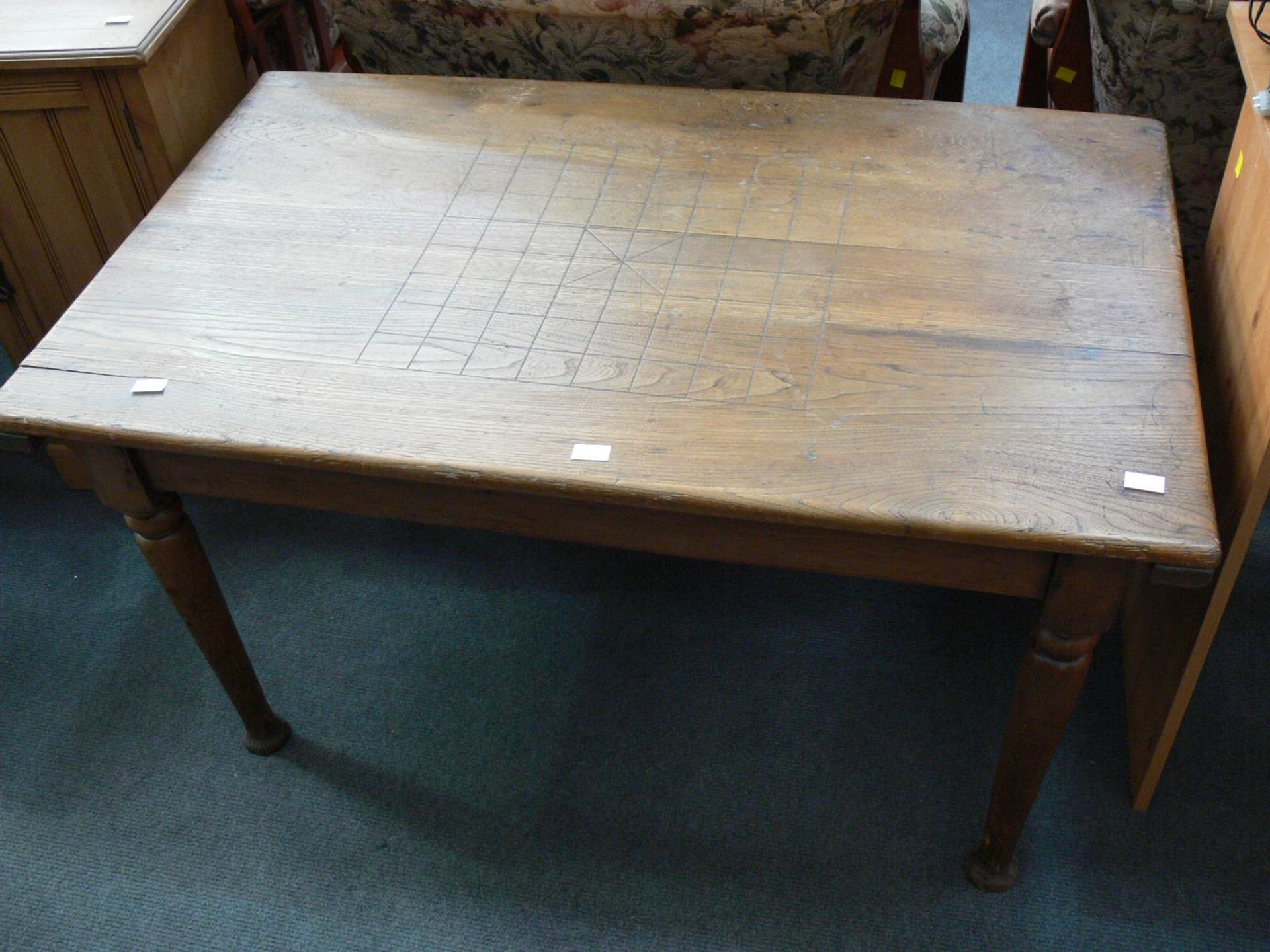 An Oak Games Table with hinged lid and turned legs. Top marked out with 64 squares to centre