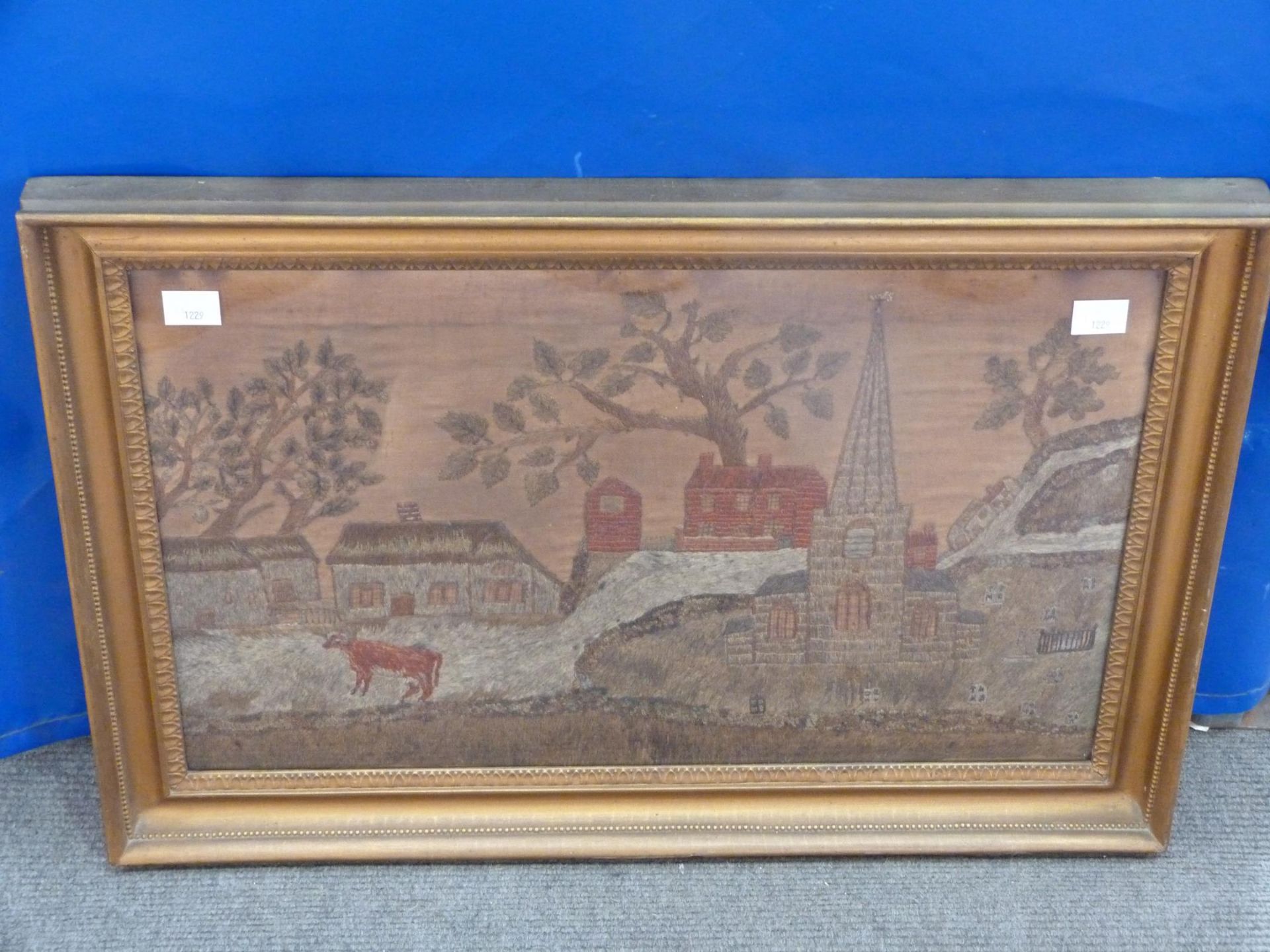 A Vintage Framed Tapestry of Church with steeple and buildings with trees (Frame 44cm x 65cm) (