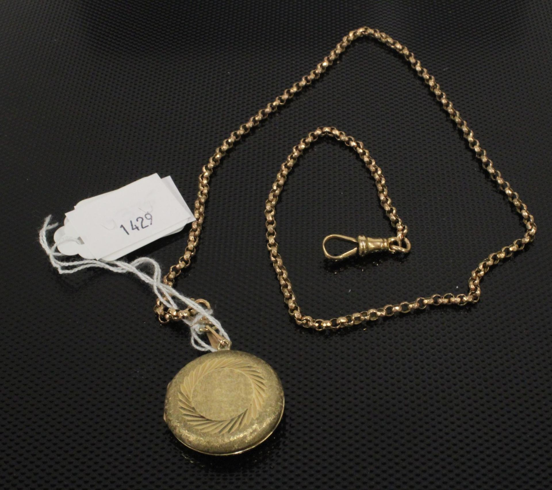 A 9ct Gold Circular Locket set on an 18ct Gold 54cms Chain. (chain approx 8gms) (Est. £150 - £300)
