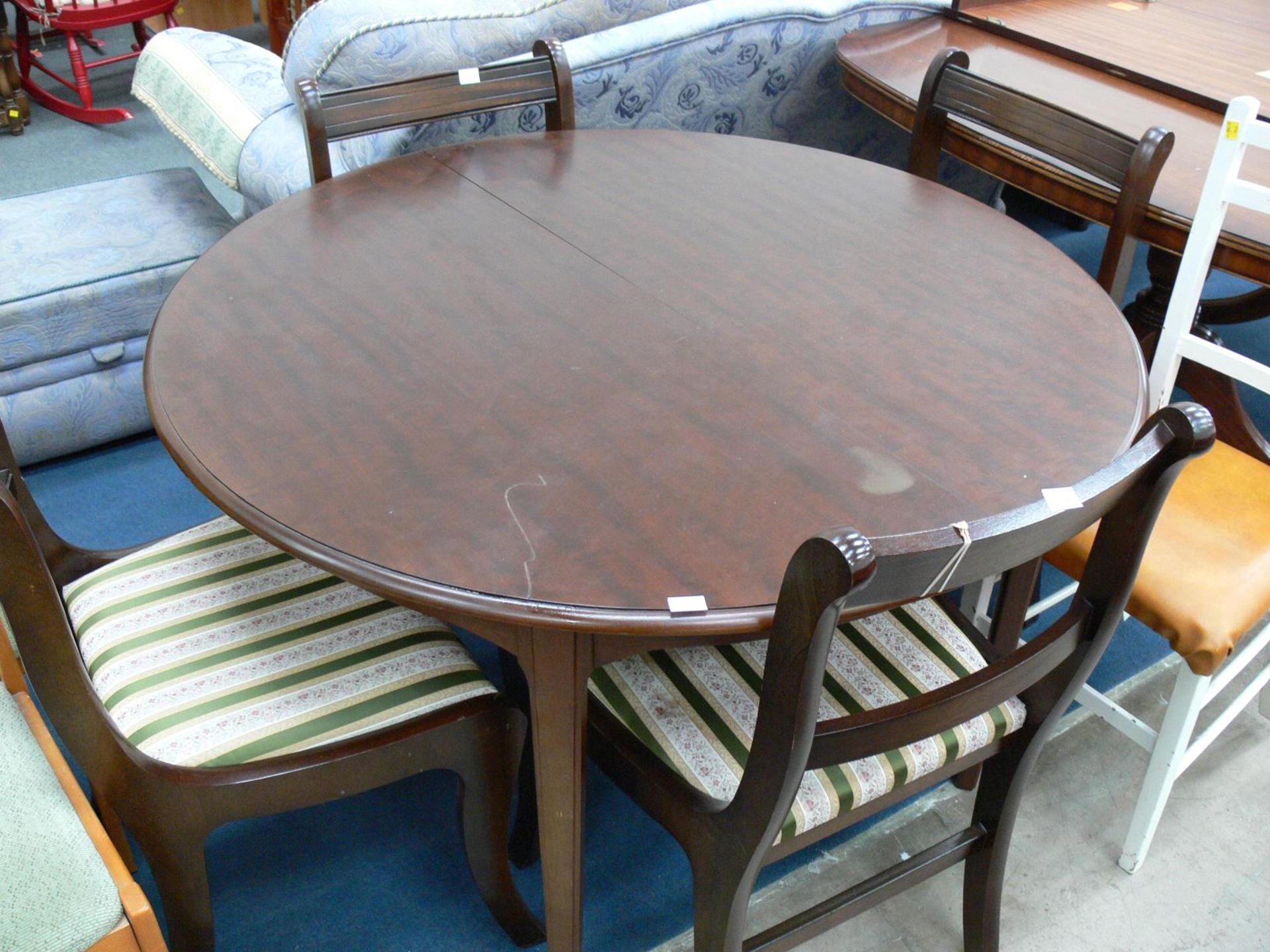 An Extending Circular Dining Table with four Chairs with striped upholstered seats (dia 116cm)