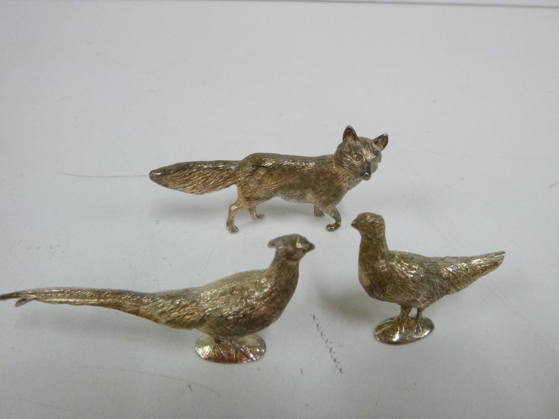 Three small Solid Silver Figures - Hen & Cock Pheasant & a Fox, London 1976 (2) and London 1973. - Image 3 of 4