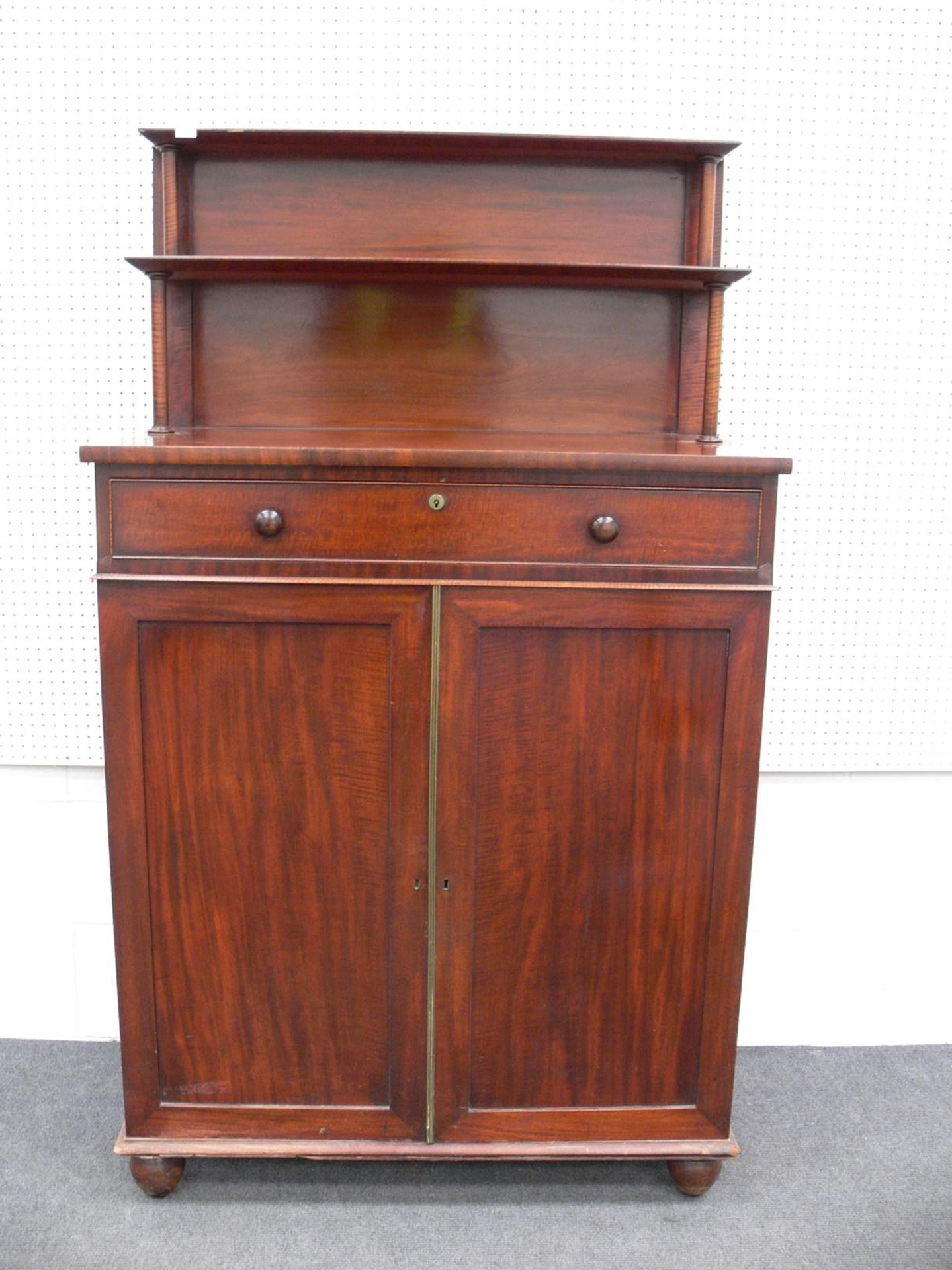 A Mahogany Antique Chiffonier with Raised Back and Two Shelves supported by Turned Columns above