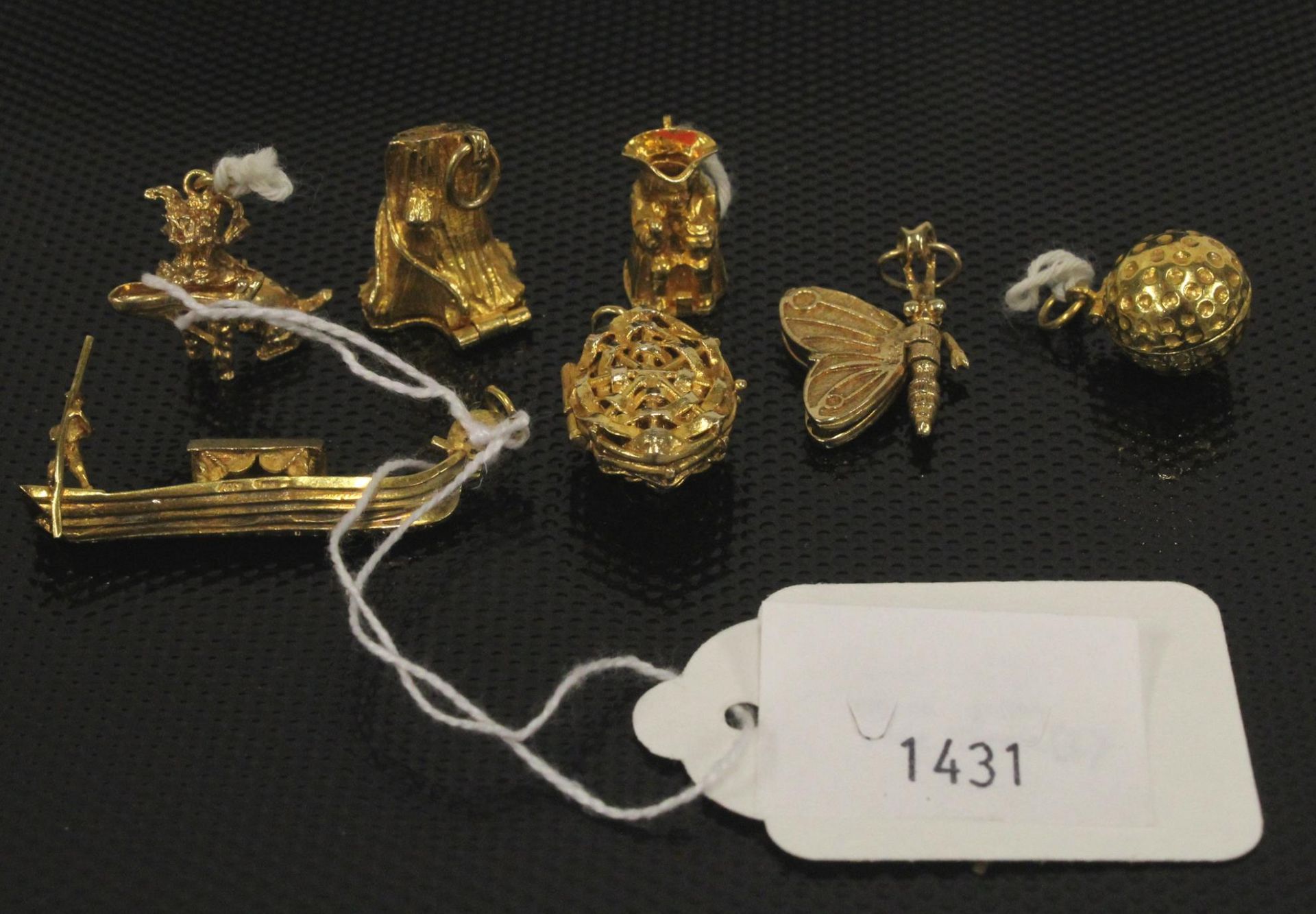 A collection of Six 9ct Gold Charms 27gms & another similar unmarked (7) (Est. £250 - £350)