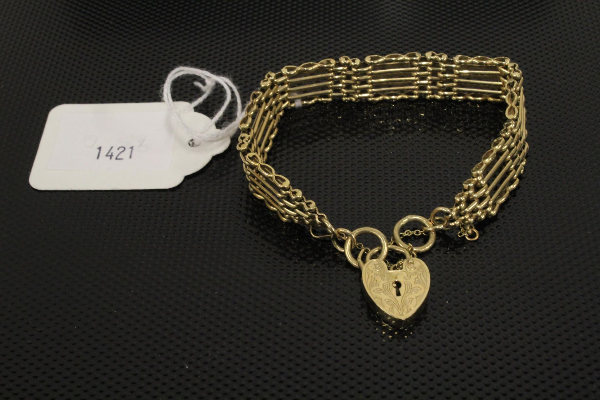 A probably 9ct Gold Gate Bracelet with a 9ct Gold padlock fastener (marks rubbed) 25gms. (Est. £