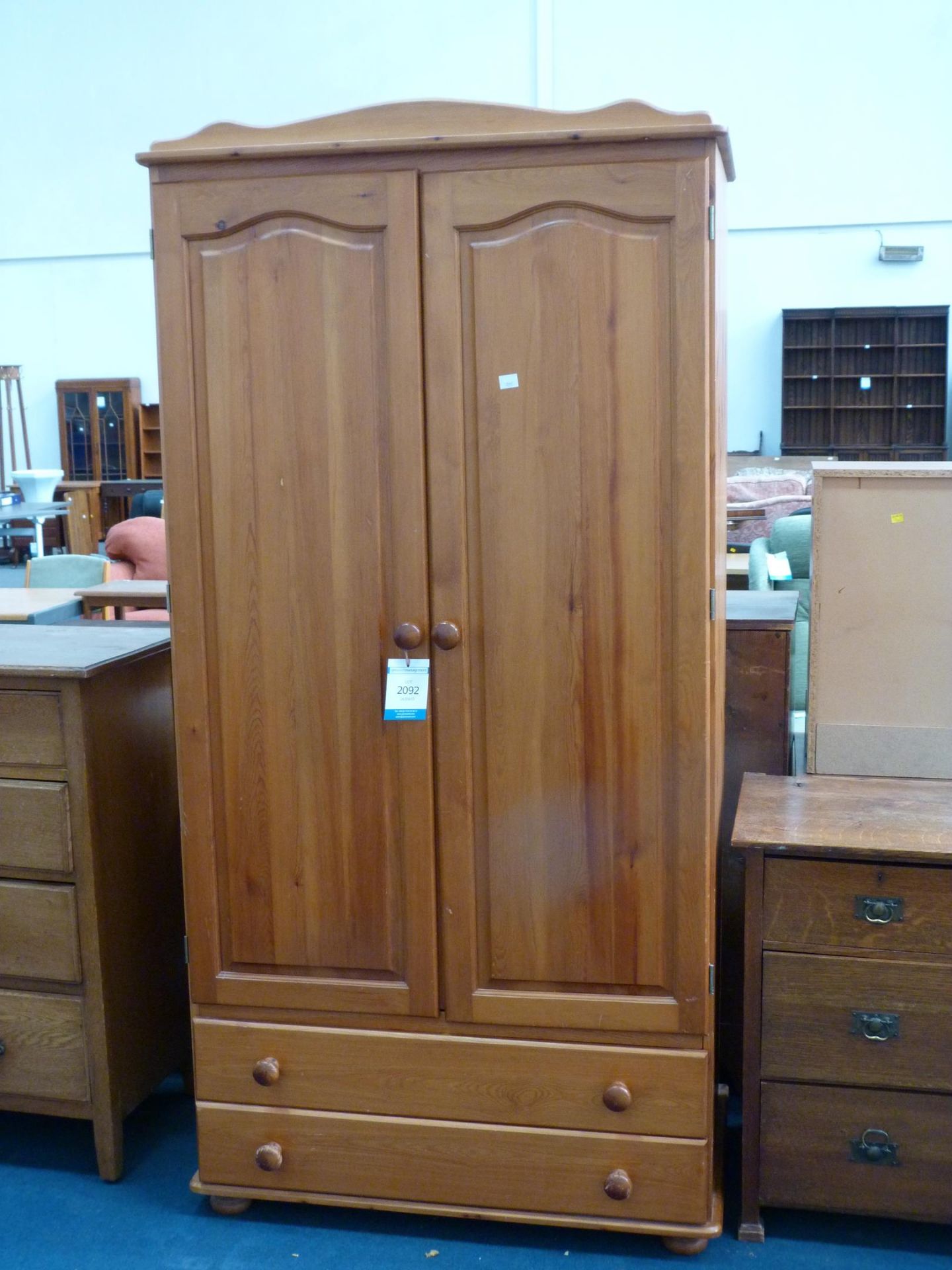 A Modern Pine two door Wardrobe with drawers to the base 96cms wide. (Est. £40- £60)