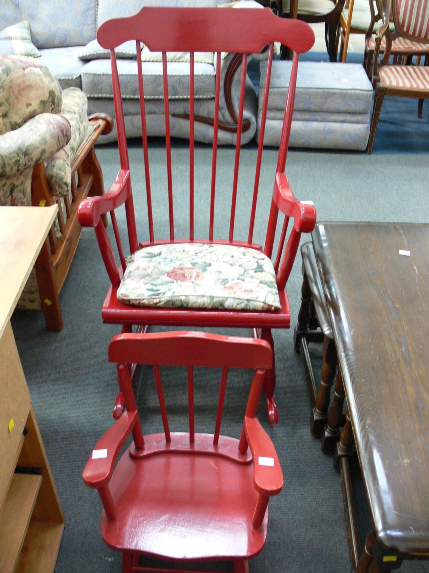 Two red painted Rocking Chairs - An adults with cushion and a child's without. (2) (Est. £20 - £40)