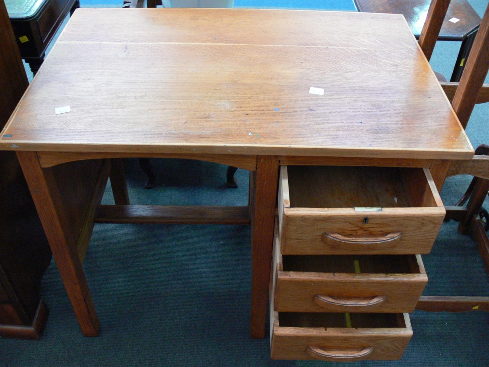 A small wooden Desk with column of three draws to the right with foot rest (H75cm W92cm D61cm). ( - Image 2 of 2