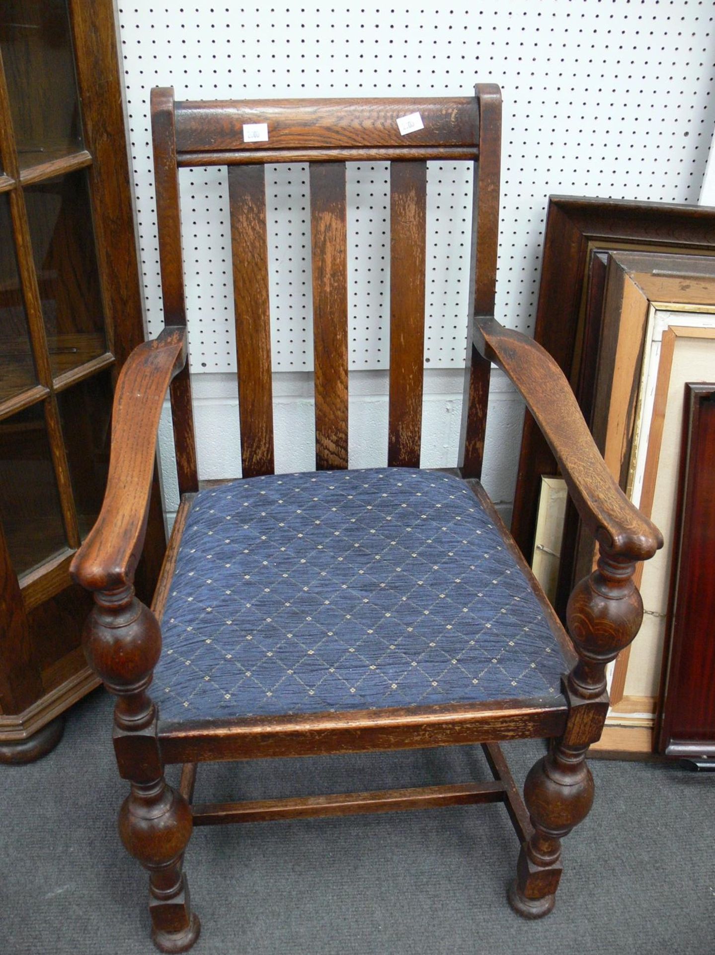 An Oak Dining Chair with carved arms and turned front legs, Plain back and upholstered patterned