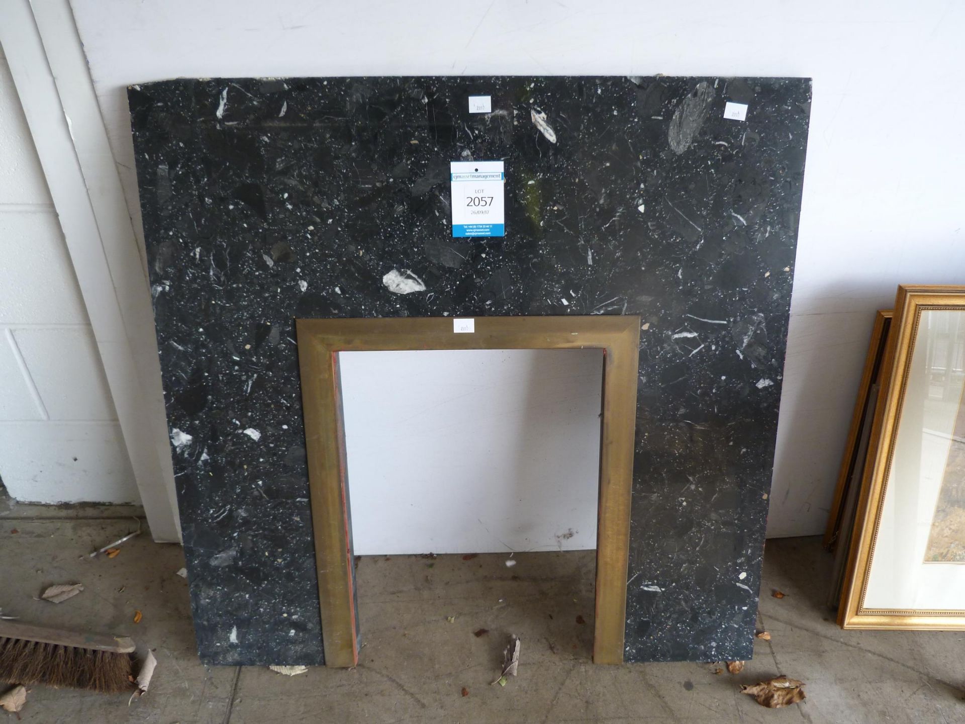 A Conglomerate Marble Fire surround with 'Brass' insert (H95cm, W94cm) (est £20-£30)