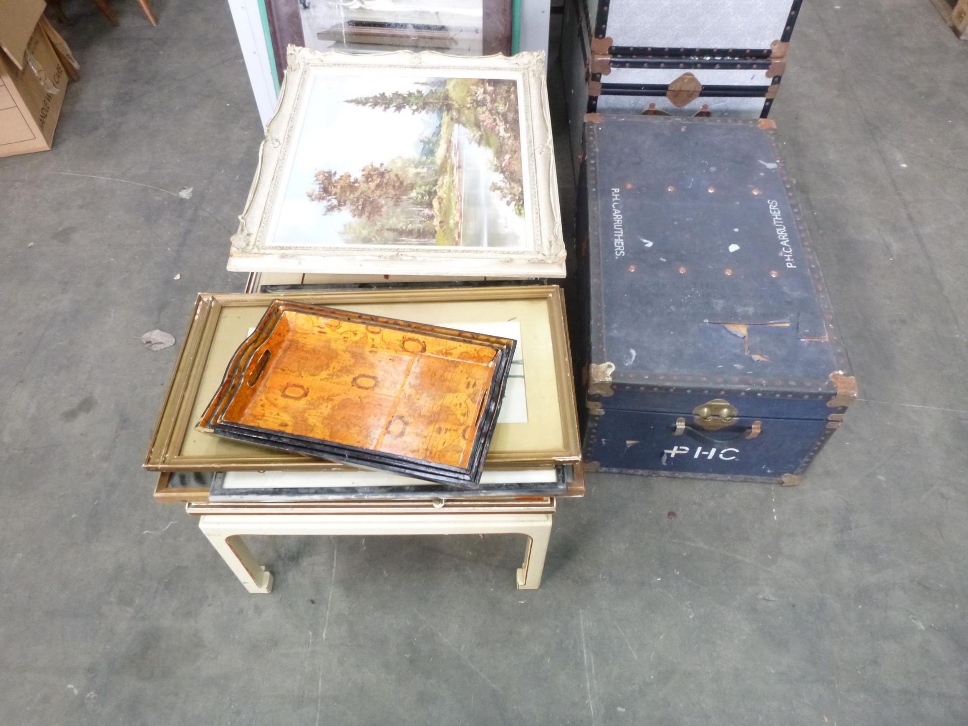 A Cream Coffee Table, various Paintings and a Trunk.