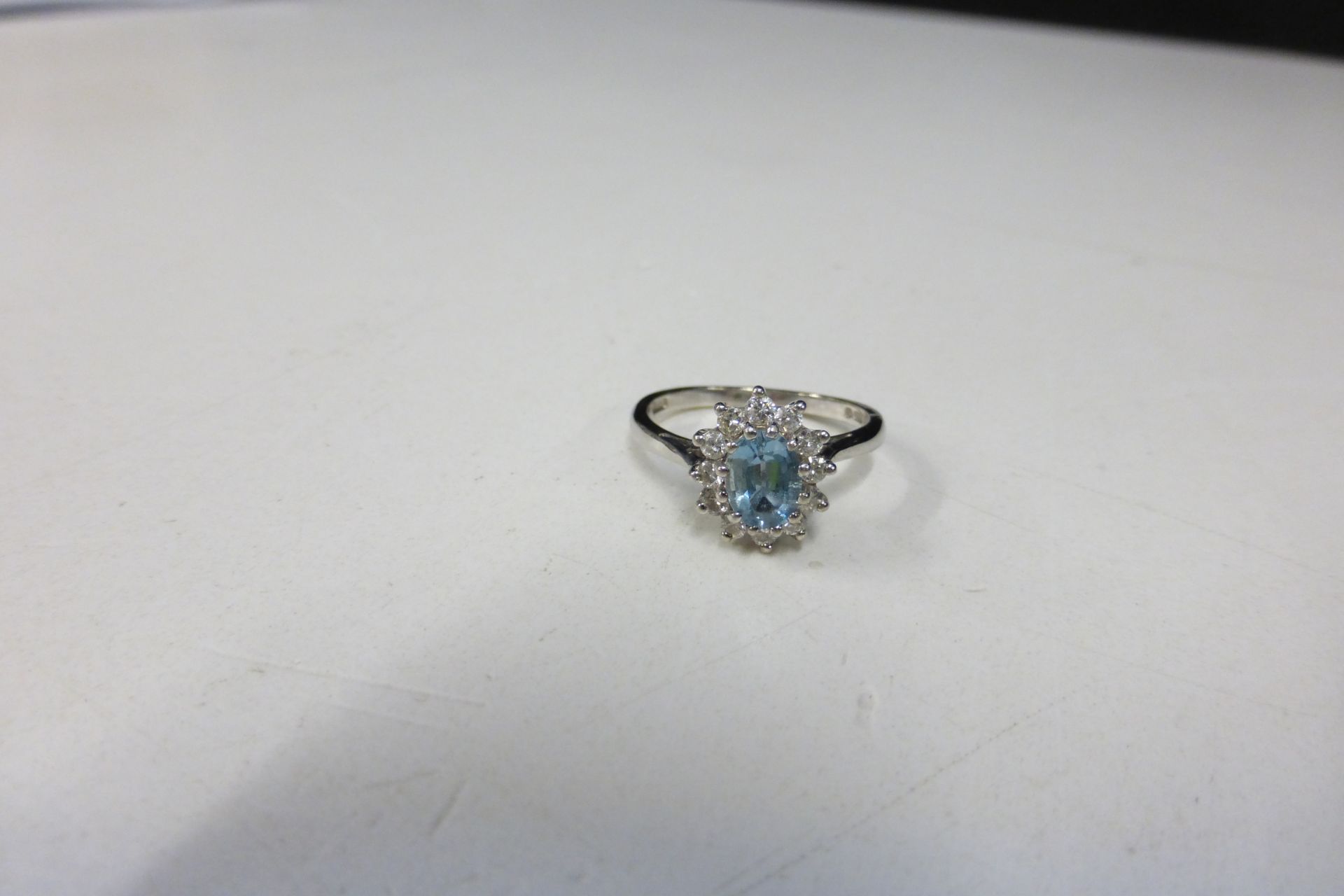 18ct White Gold Solitaire Aquamarine and Diamond Cluster Ring, size P (boxed). (Est. £850 - £1000)