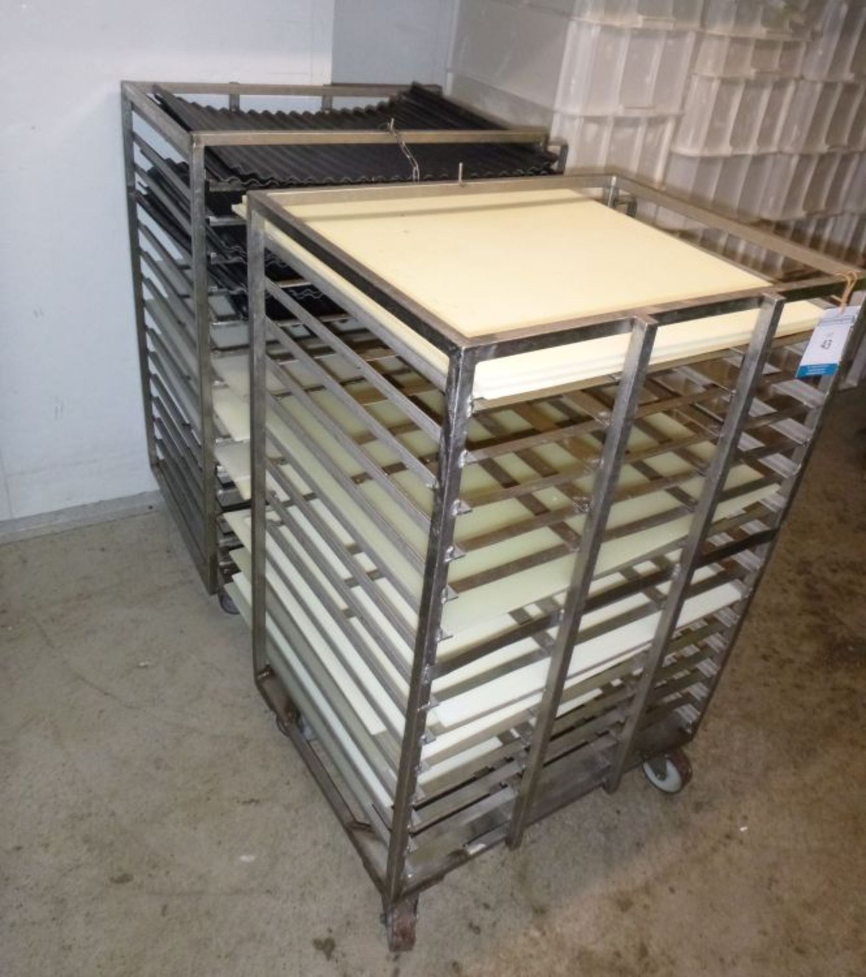 * 2 x Low height Stainless Steel Trollies with flat white acrylic boards and corrugated black