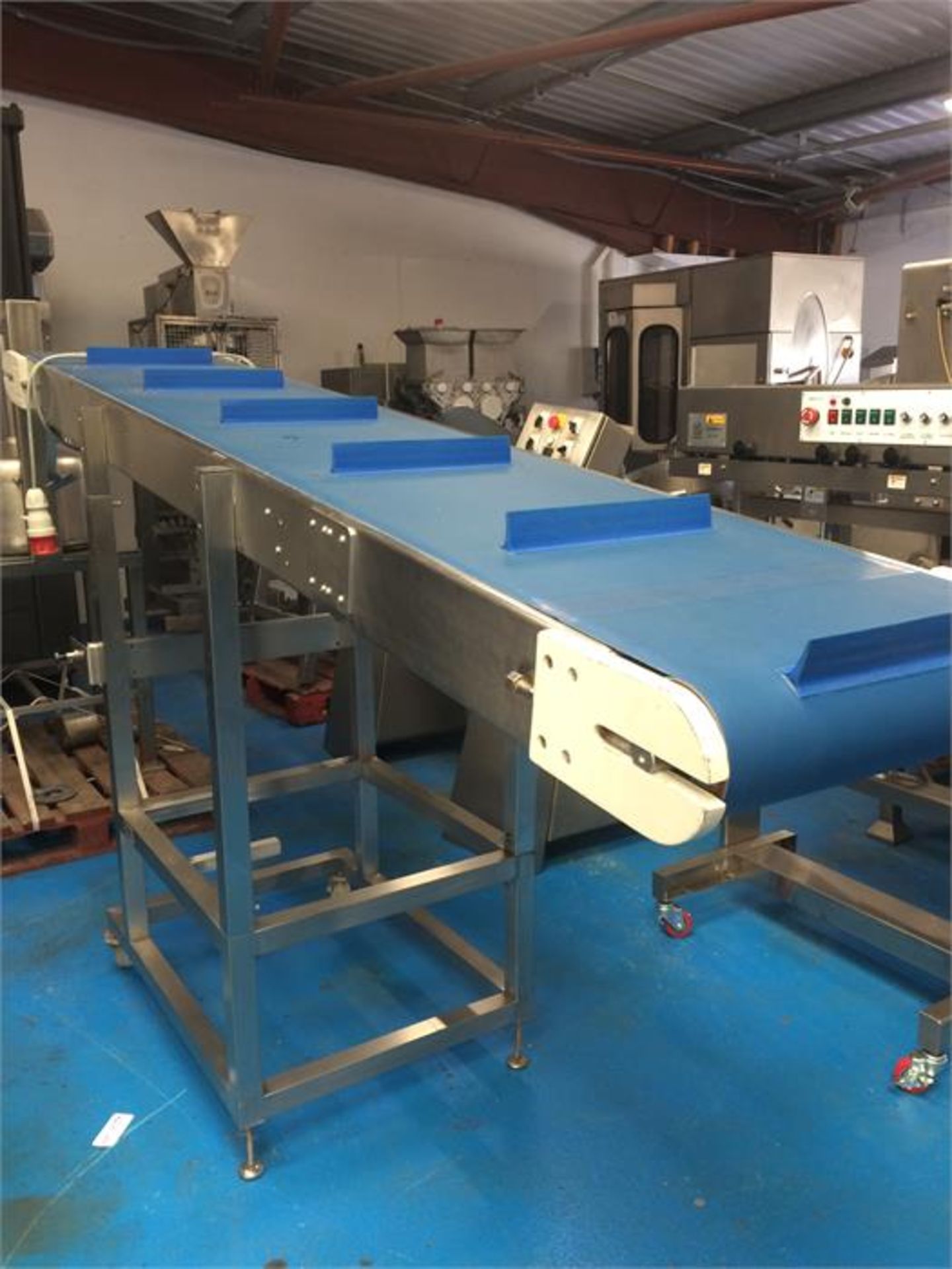 1 x All s/s framed neoprene belt incline transfer conveyor. Taking product from a height of 1200mm