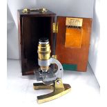 A brass and steel microscope, boxed 18cm high