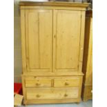 A 19th century stripped pine linen press, a pair of doors above two short & one long drawer,on bun