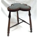 A late 19th century stool, the upholstered "Club" shaped seat on three turned legs.