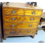 An early 19th century mahogany chest with two short and three graduated long drawers, standing on