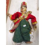 A Thai carved and painted wooden puppet 38cm high.