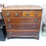An early 19th century oak chest, with two short and three graduated long drawers, on bracket feet,