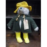 A Vintage Gabrielle Paddington Bear compete with a rare yellow dunlop wellies and parcel label