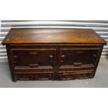 An 18th century oak mule chest with panelled front and plank top, 127cm wide.