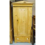 A Victorian stripped pine single wardrobe, with single door above one long drawer, 91cm wide.