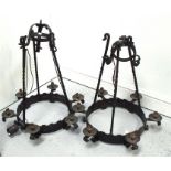 A pair of wrought iron chandeliers, 80cm high.