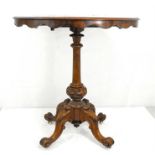 A Victorian walnut tilt-top occasional table on carved and turned column with quatrofoil base,
