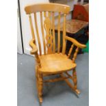 A country farmhouse beech rocking chair with pierced splat, on turned supports.