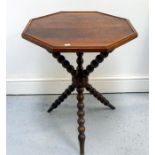 An octagonal figured walnut gypsy table on turned legs 55cm wide