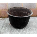 A large cast iron bowl or planter 53cm diameter