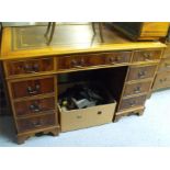 A reproduction yew wood pedestal desk with a combination of 9 drawers - 123cm wide