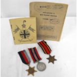 A WWII medal group of three including the Burma Star with his release book, named to Gunner W.J.