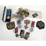 A WWII medal trio including the 1939-1945 Star, war medal and defense medal, a boxed British