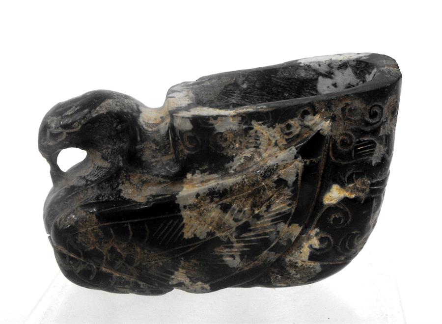 A mottled jade libation cup in the form of a bird 5.5cm high (possibly cut down)